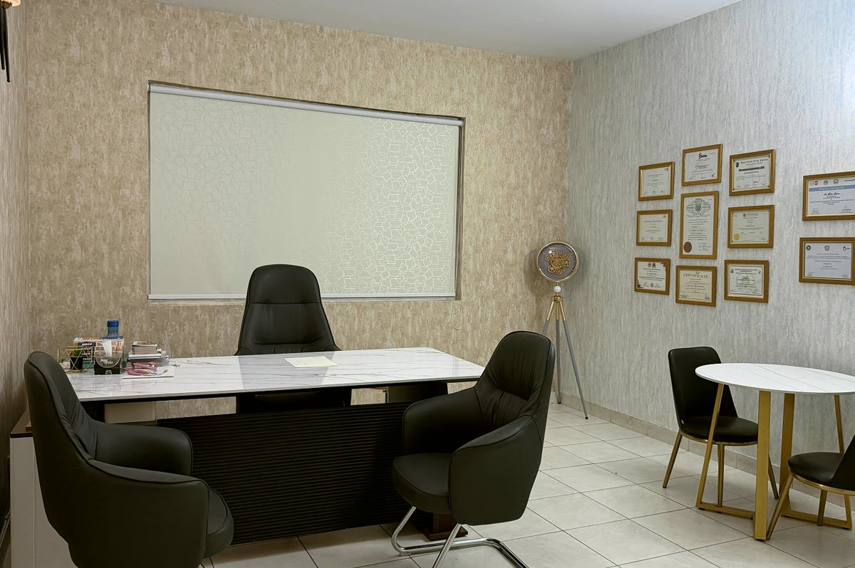 The consultation room, a desk with chairs on both sides